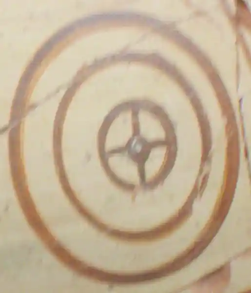 Cross inside three circles with a circle at the center